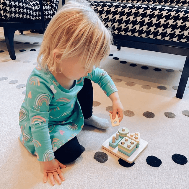 Child playing with the Sort & Stack Peg Puzzle from The Enthusiast Play Kit